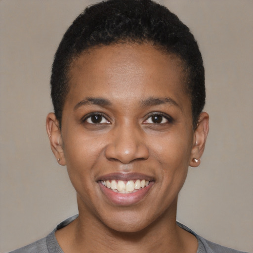 Joyful black young-adult female with short  brown hair and brown eyes