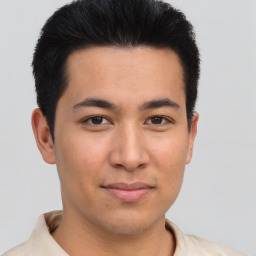 Joyful asian young-adult male with short  brown hair and brown eyes