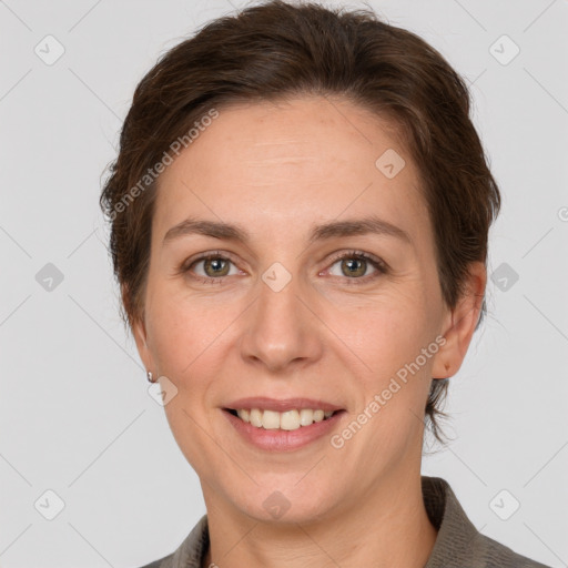 Joyful white adult female with short  brown hair and grey eyes