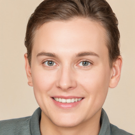 Joyful white young-adult female with short  brown hair and grey eyes