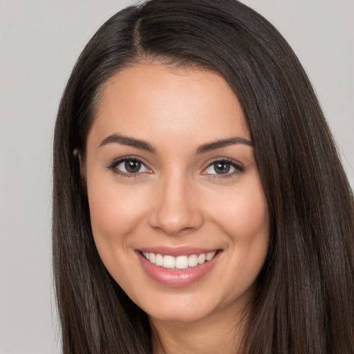 Joyful white young-adult female with long  brown hair and brown eyes