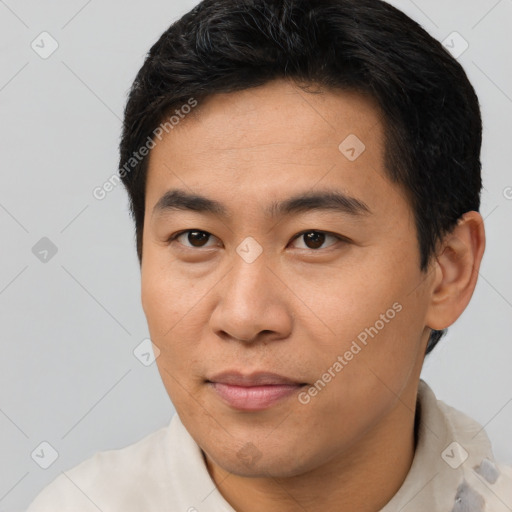 Joyful asian young-adult male with short  brown hair and brown eyes