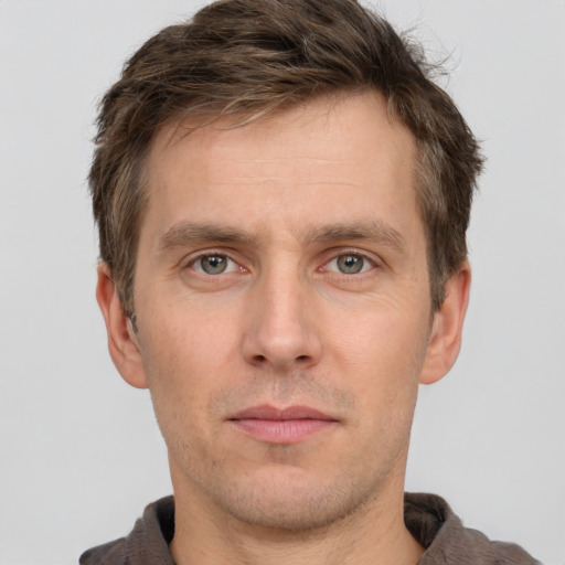 Joyful white adult male with short  brown hair and grey eyes