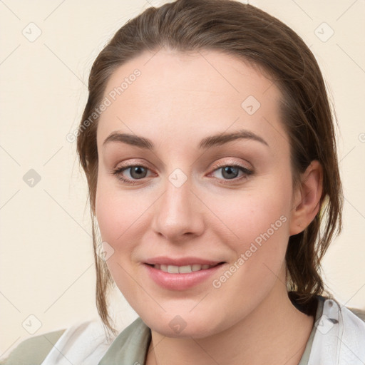 Joyful white young-adult female with medium  brown hair and grey eyes