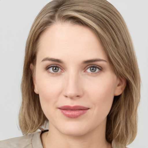 Joyful white young-adult female with medium  brown hair and green eyes