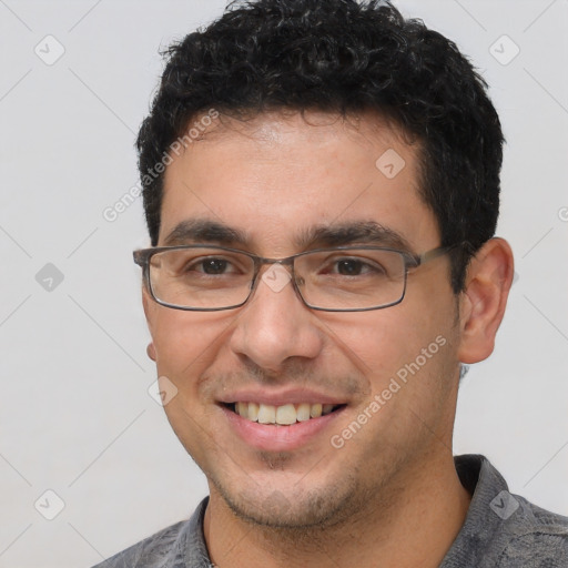 Joyful white young-adult male with short  black hair and brown eyes