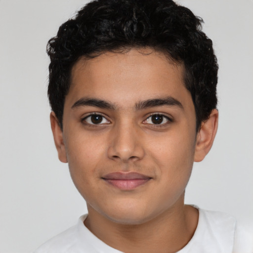 Joyful latino child male with short  brown hair and brown eyes