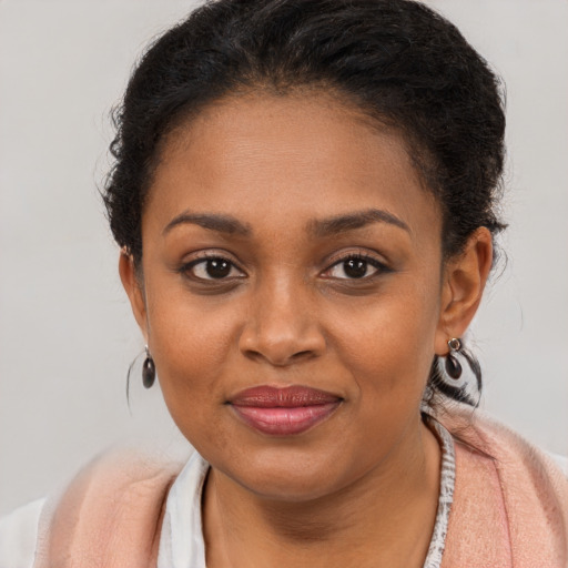 Joyful black young-adult female with short  brown hair and brown eyes