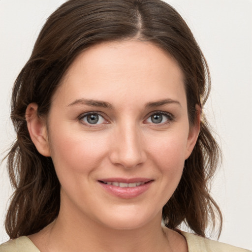 Joyful white young-adult female with medium  brown hair and grey eyes