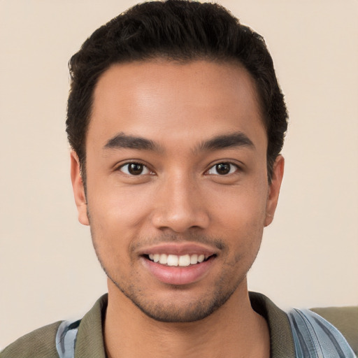 Joyful white young-adult male with short  black hair and brown eyes