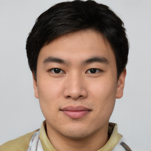 Joyful asian young-adult male with short  brown hair and brown eyes