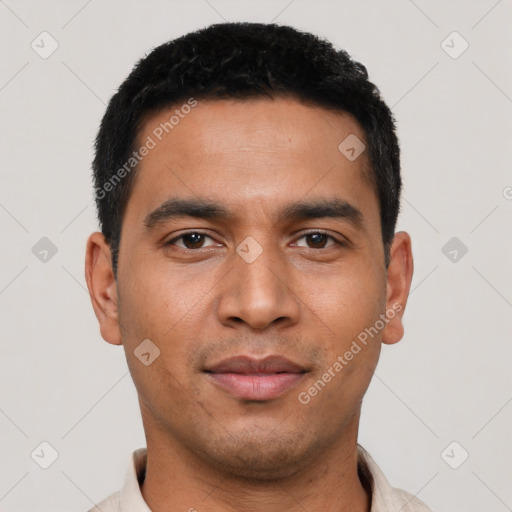 Joyful latino young-adult male with short  black hair and brown eyes