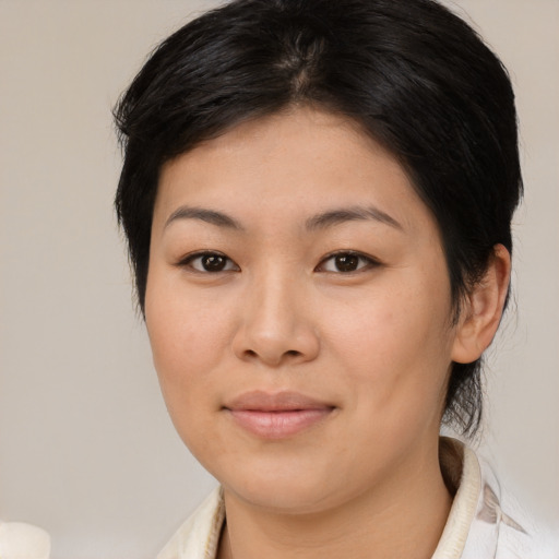 Joyful asian young-adult female with medium  brown hair and brown eyes