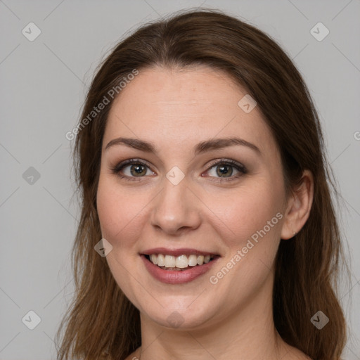 Joyful white young-adult female with long  brown hair and green eyes