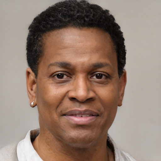 Joyful black adult male with short  brown hair and brown eyes