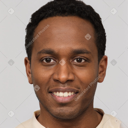 Joyful black young-adult male with short  black hair and brown eyes