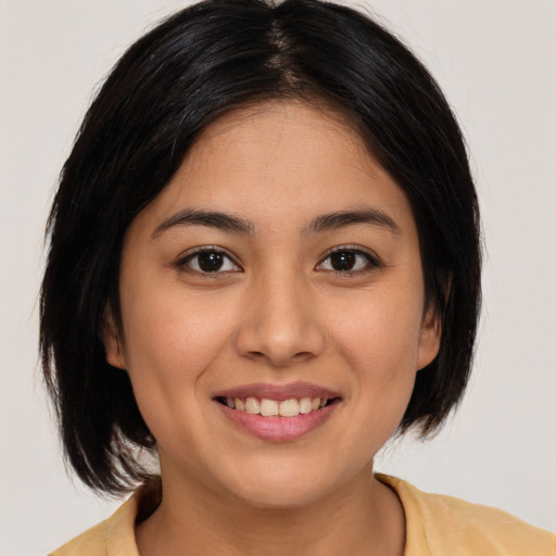 Joyful latino young-adult female with medium  black hair and brown eyes