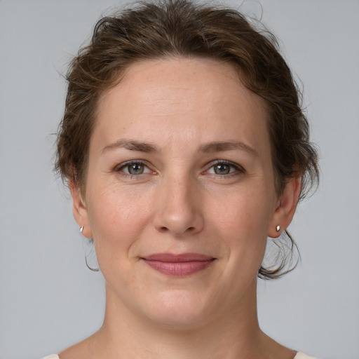 Joyful white adult female with medium  brown hair and grey eyes