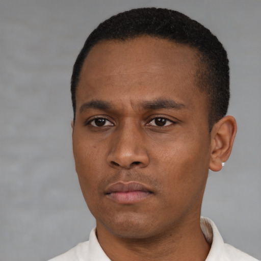 Neutral latino young-adult male with short  black hair and brown eyes