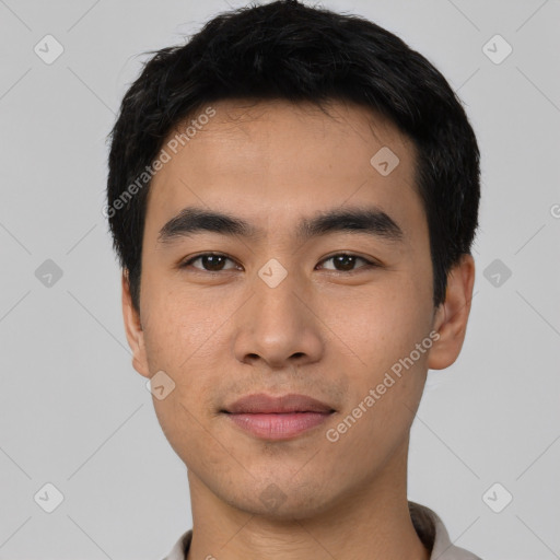 Joyful asian young-adult male with short  black hair and brown eyes