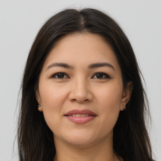 Joyful latino young-adult female with long  brown hair and brown eyes