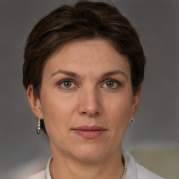 Joyful white adult female with short  brown hair and grey eyes