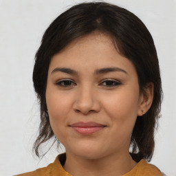 Joyful latino young-adult female with medium  brown hair and brown eyes