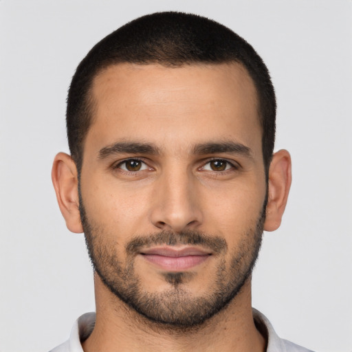 Joyful latino young-adult male with short  brown hair and brown eyes