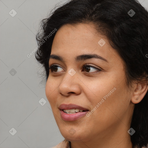 Joyful black young-adult female with medium  brown hair and brown eyes