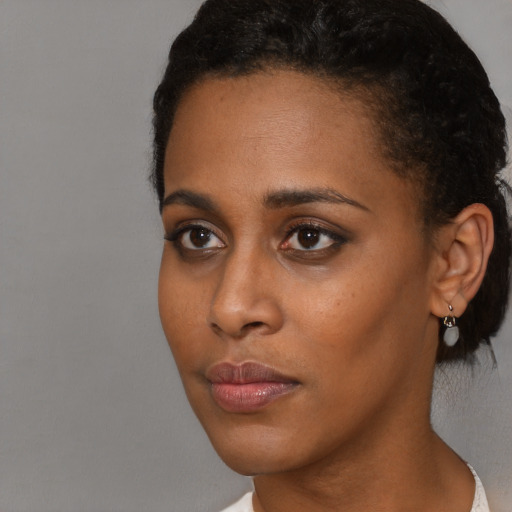 Neutral black young-adult female with short  brown hair and brown eyes