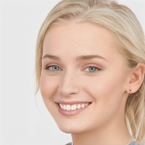 Joyful white young-adult female with long  brown hair and blue eyes