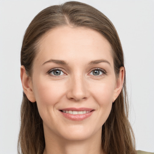 Joyful white young-adult female with long  brown hair and grey eyes