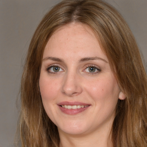 Joyful white young-adult female with long  brown hair and green eyes