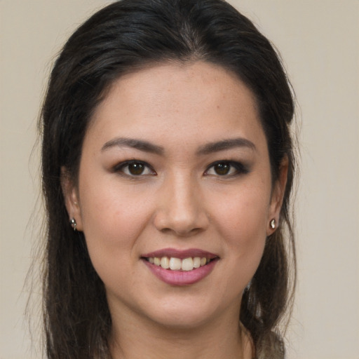 Joyful latino young-adult female with long  brown hair and brown eyes