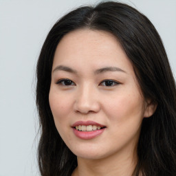 Joyful asian young-adult female with long  brown hair and brown eyes