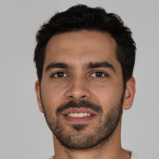 Joyful white young-adult male with short  black hair and brown eyes