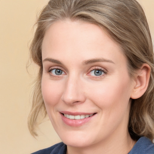 Joyful white young-adult female with medium  brown hair and blue eyes