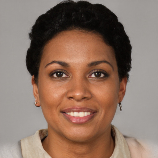 Joyful black young-adult female with short  brown hair and brown eyes