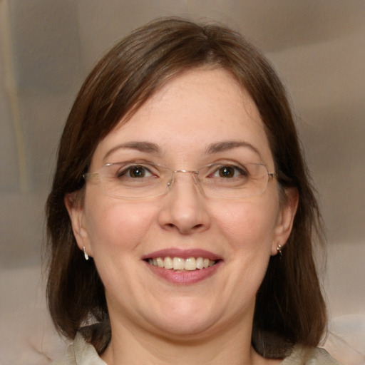 Joyful white adult female with medium  brown hair and brown eyes