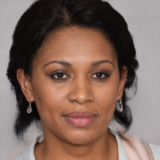Joyful black young-adult female with medium  brown hair and brown eyes