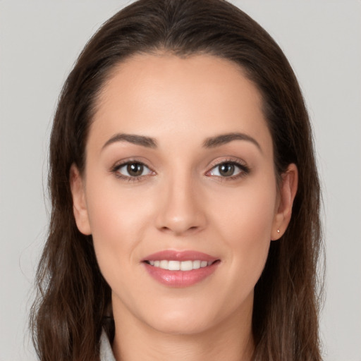 Joyful white young-adult female with long  brown hair and brown eyes