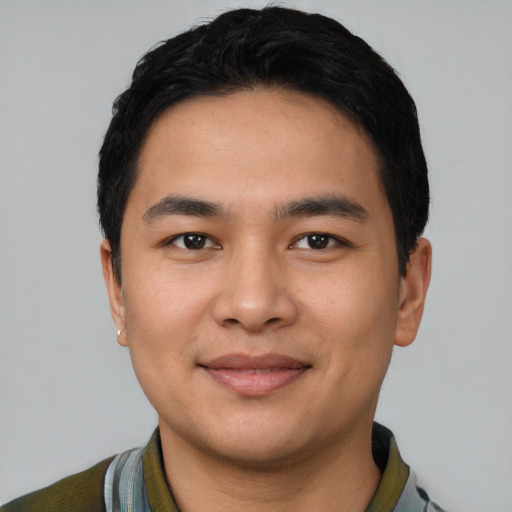 Joyful latino young-adult male with short  black hair and brown eyes
