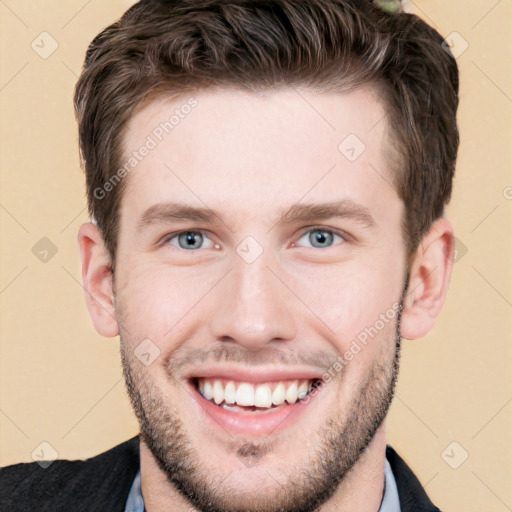 Joyful white young-adult male with short  brown hair and grey eyes