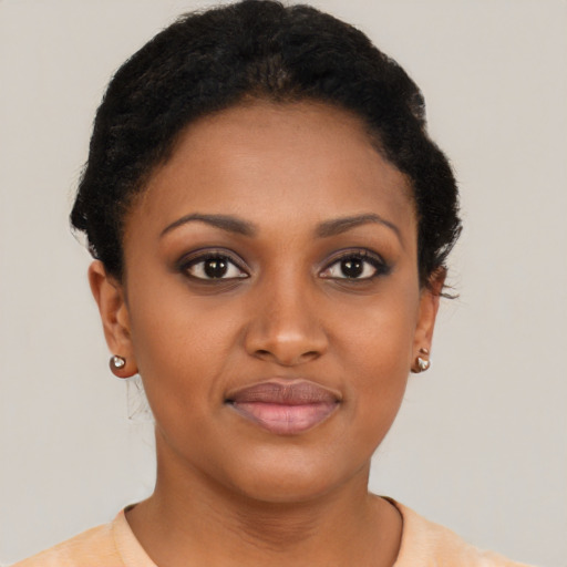 Joyful black young-adult female with short  black hair and brown eyes