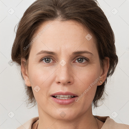 Joyful white adult female with medium  brown hair and grey eyes