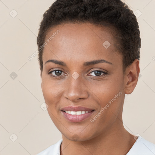 Joyful black young-adult female with short  brown hair and brown eyes