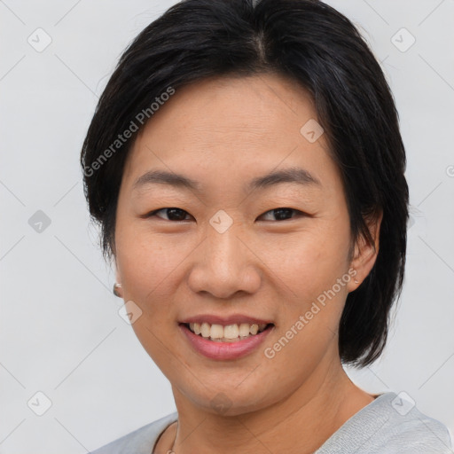 Joyful asian young-adult female with short  brown hair and brown eyes