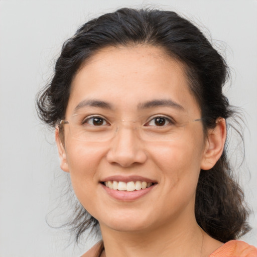 Joyful asian adult female with medium  brown hair and brown eyes
