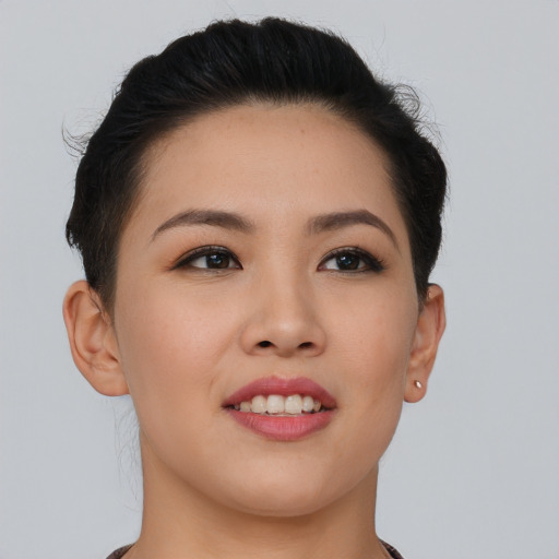 Joyful asian young-adult female with short  brown hair and brown eyes