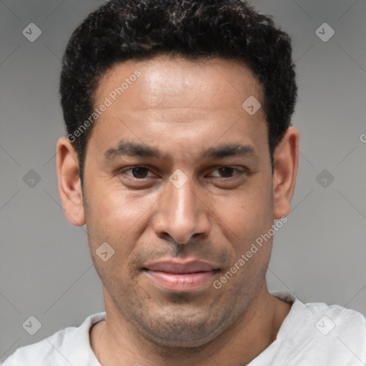 Joyful latino young-adult male with short  brown hair and brown eyes